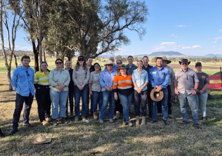 Soil science professionals participating in outdoor field research in rural Australia.